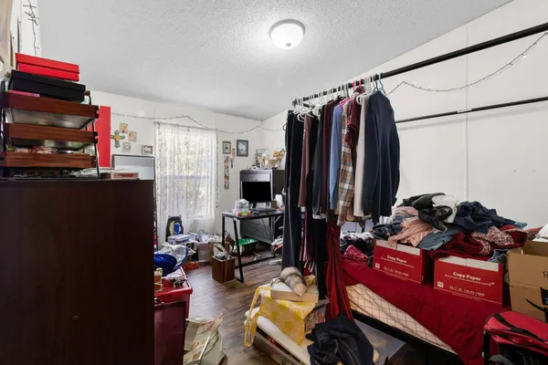 a view of a livingroom with workspace and a window