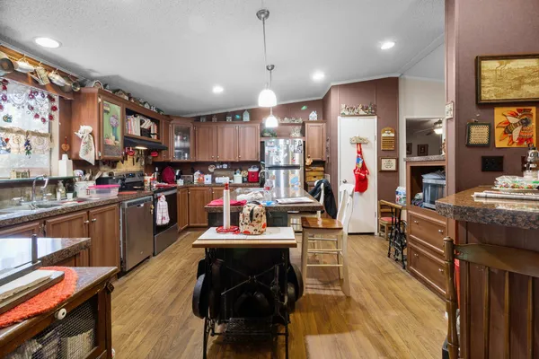 a living room with lots of furniture and kitchen view