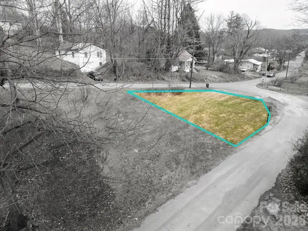 a view of a swimming pool with a yard and seating area