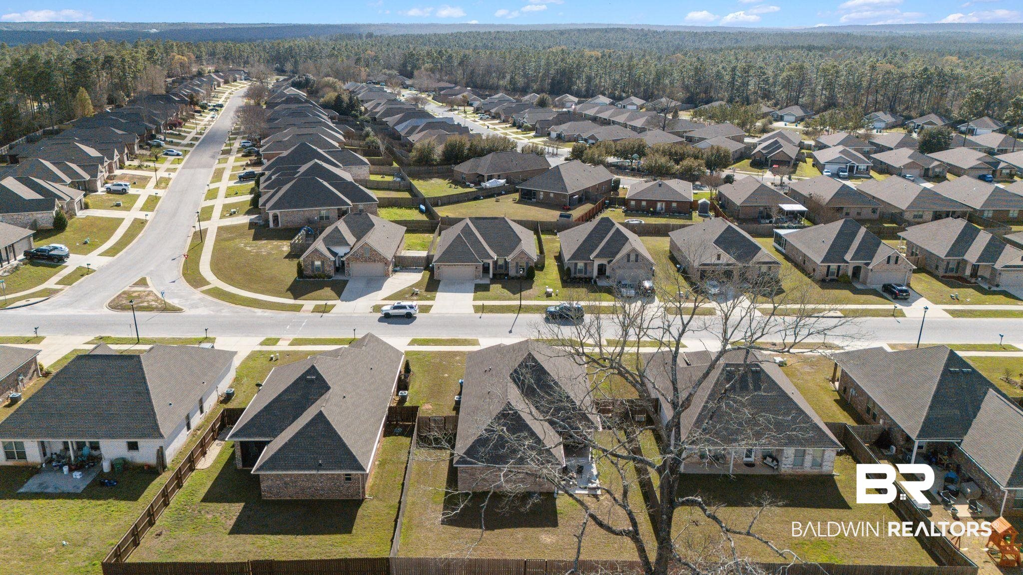 10745 Brodick Loop Daphne, AL 36527 - Photo 32 of 39 Aerial perspective of suburban area with a heavily wooded area
