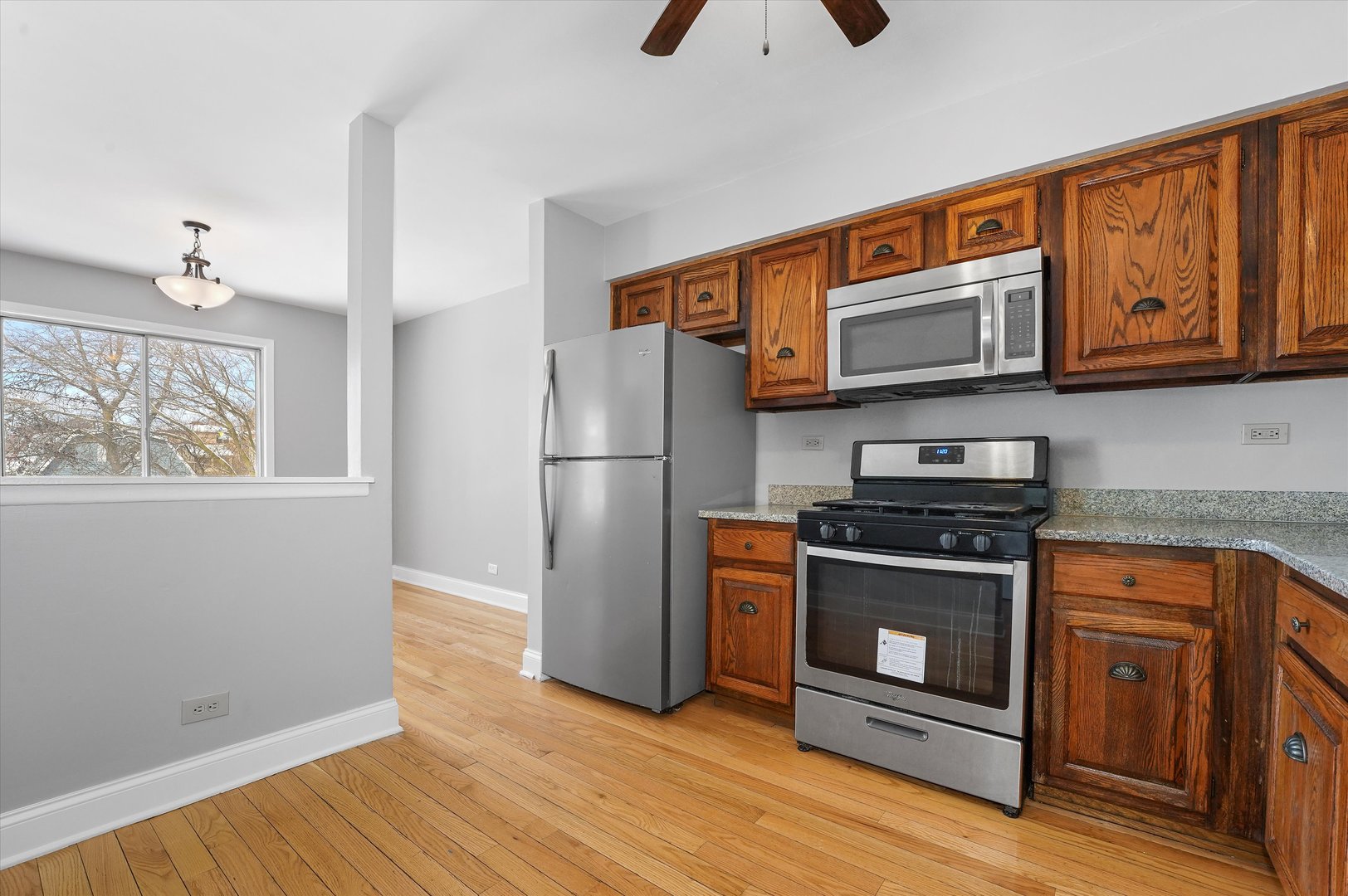210 Mill Stream Drive Bolingbrook, IL 60440 - Photo 13 of 39 a kitchen with stainless steel appliances granite countertop a stove a refrigerator and a microwave