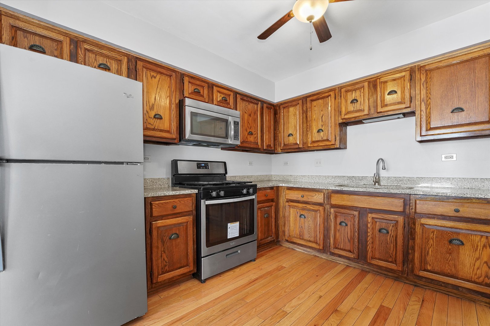 210 Mill Stream Drive Bolingbrook, IL 60440 - Photo 14 of 39 a kitchen with stainless steel appliances granite countertop a refrigerator a stove top oven a sink and dishwasher with wooden floor
