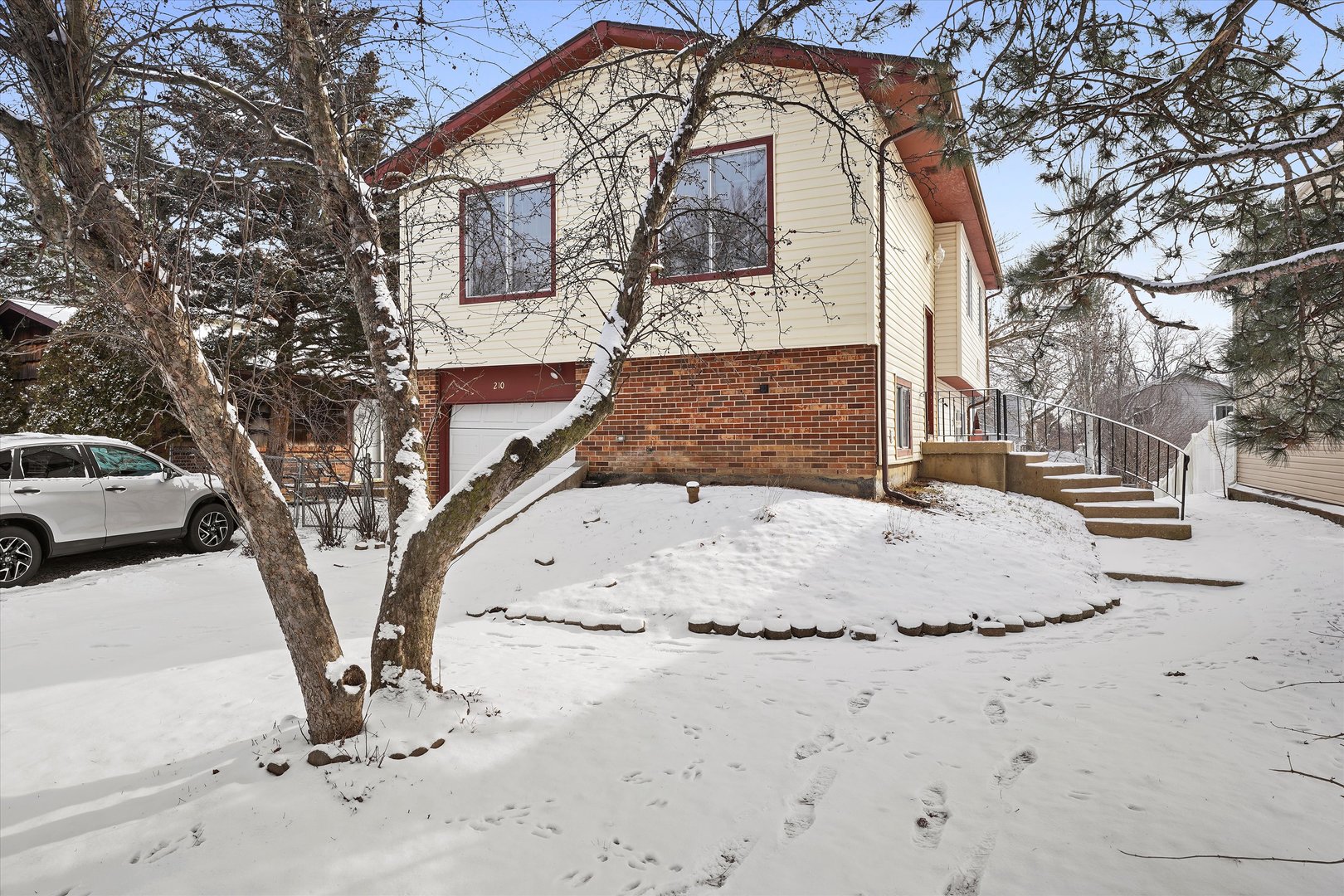 210 Mill Stream Drive Bolingbrook, IL 60440 - Photo 3 of 39 a view of white house with a snow on the road