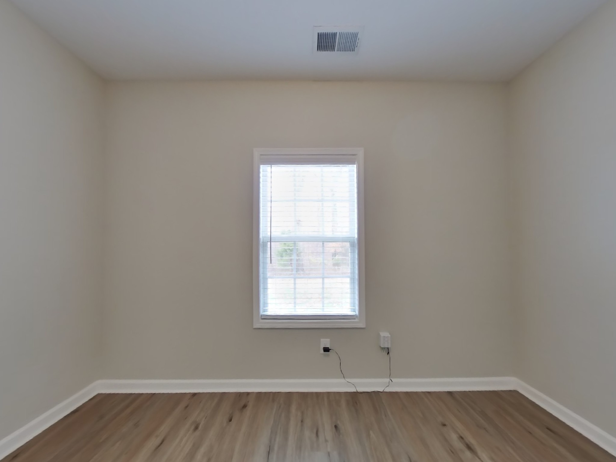 825 Ellyson Drive Spring Hill, TN 37174 - Photo 12 of 17 a view of an empty room with wooden floor and a window