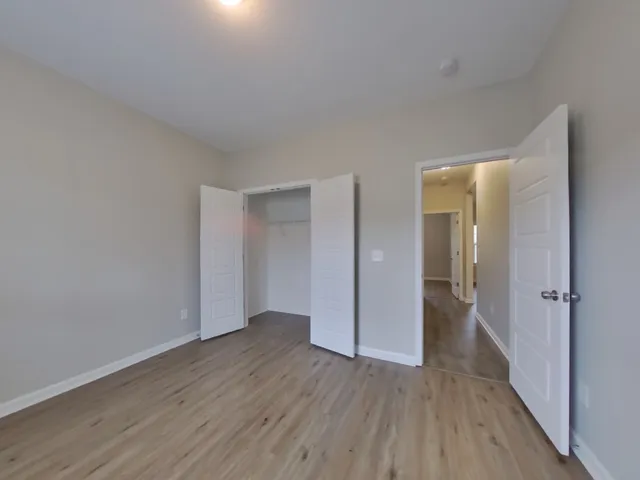 a view of an empty room and wooden floor