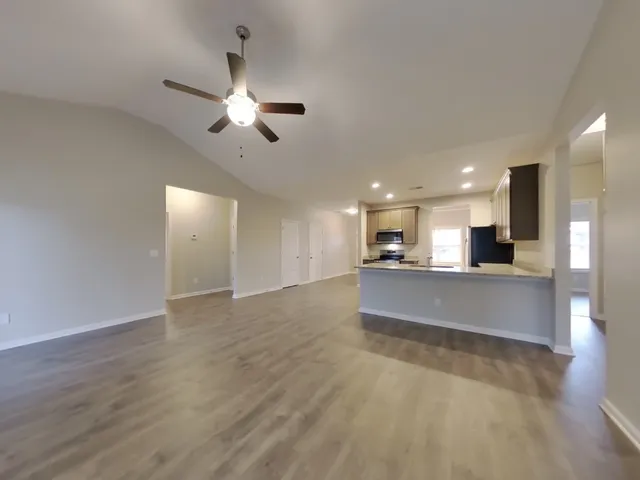a view of kitchen with refrigerator microwave and stove