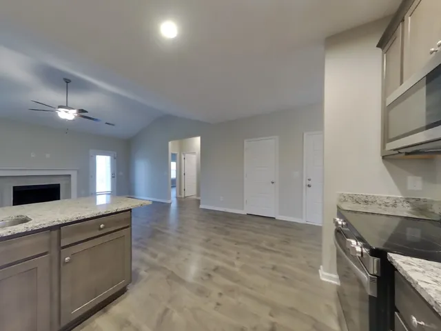 a view of a kitchen with a sink and a fireplace