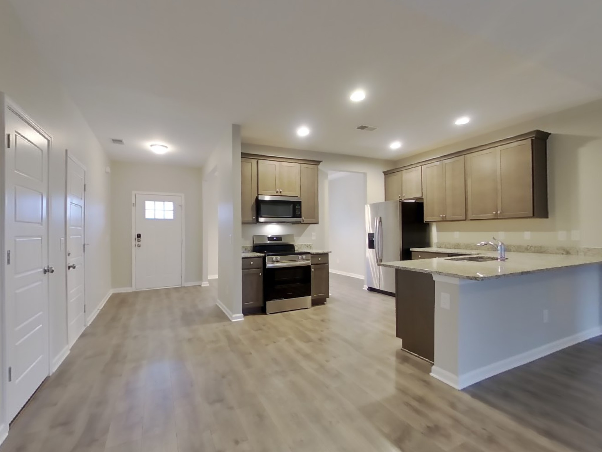 825 Ellyson Drive Spring Hill, TN 37174 - Photo 7 of 17 a kitchen with stainless steel appliances kitchen island granite countertop a stove and a sink