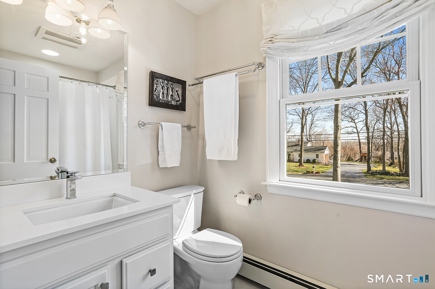 757 Galloping Hill Road Fairfield, CT 06824 - Photo 24 of 30 a bathroom with a sink a toilet a window and a mirror
