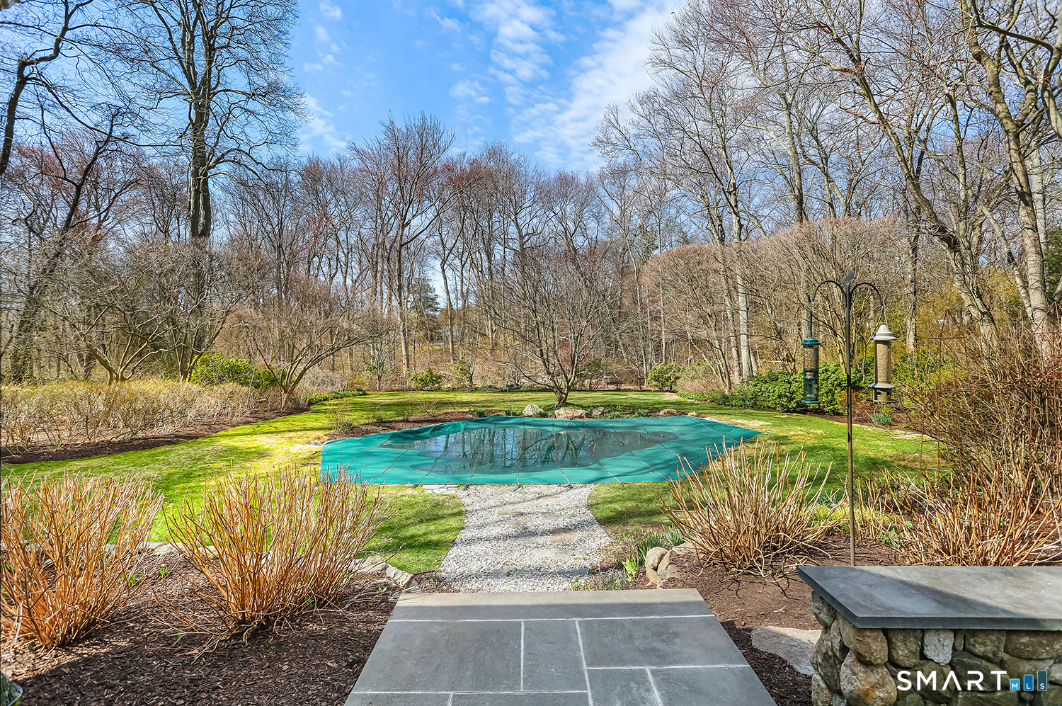 757 Galloping Hill Road Fairfield, CT 06824 - Photo 25 of 30 a view of a backyard with plants and large trees