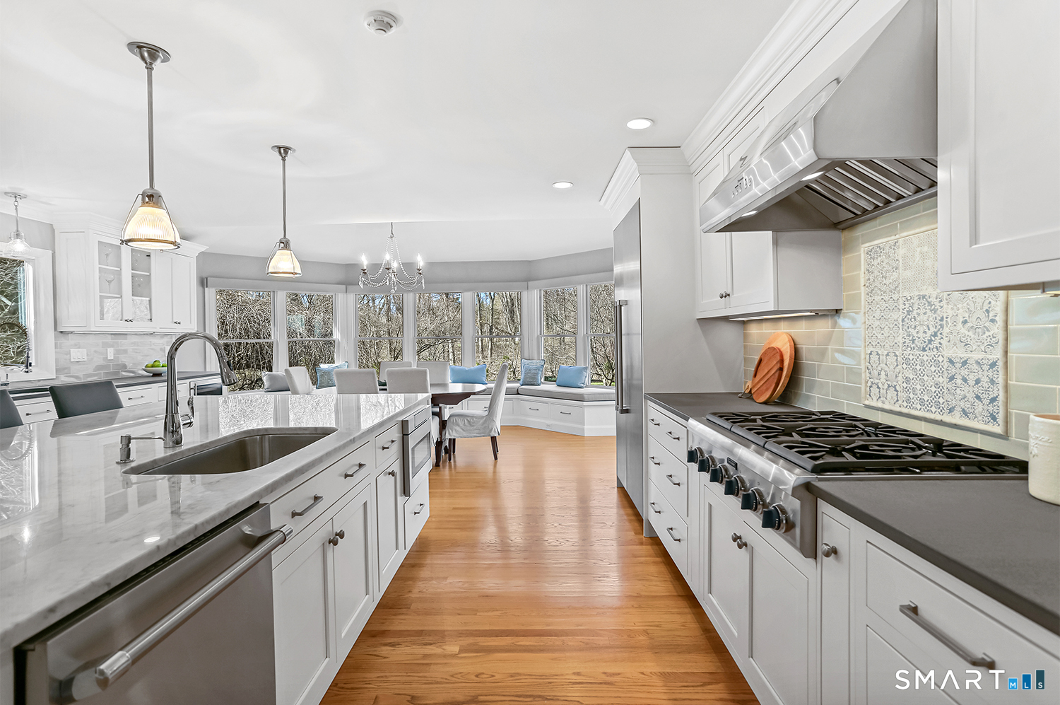 757 Galloping Hill Road Fairfield, CT 06824 - Photo 3 of 30 a kitchen with granite countertop a stove and a sink
