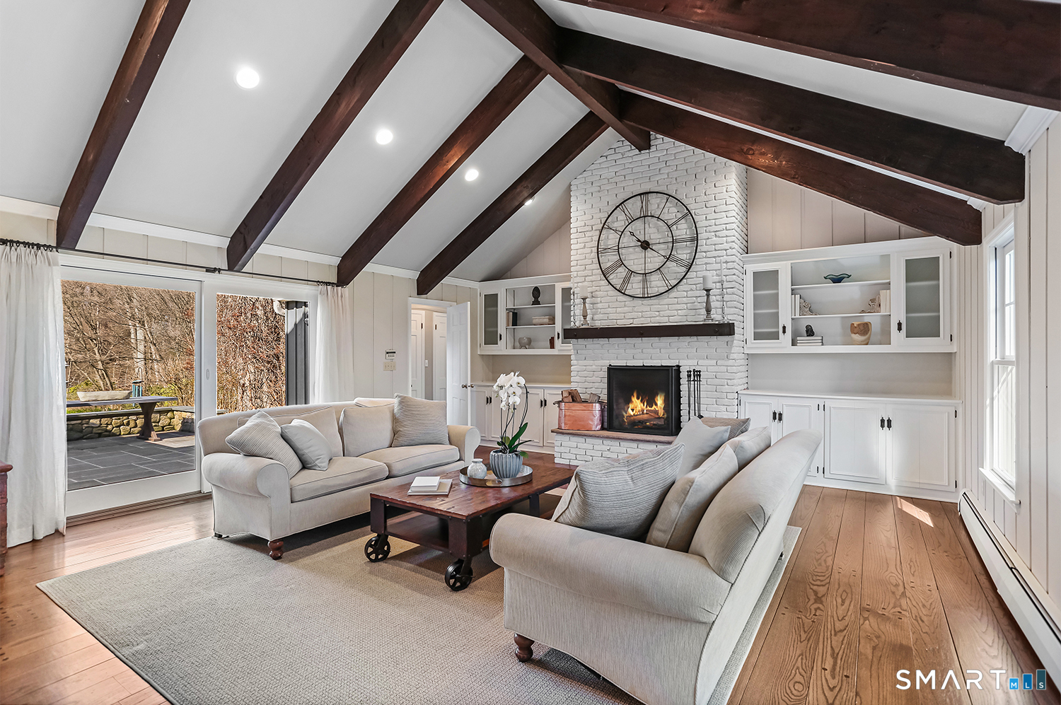 757 Galloping Hill Road Fairfield, CT 06824 - Photo 6 of 30 a living room with furniture a clock and a fireplace