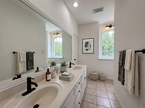 a bathroom with a sink double vanity and a window