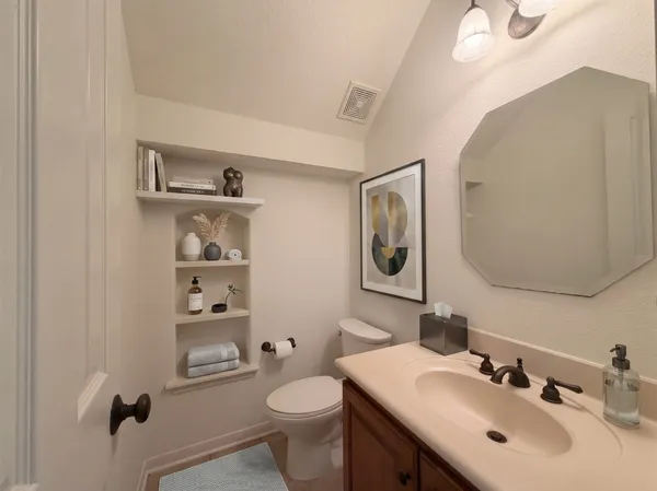 a bathroom with a sink toilet and mirror