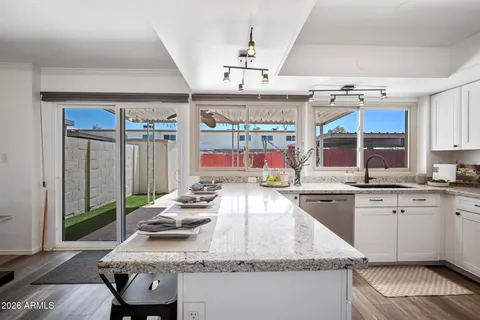 a kitchen with cabinets stainless steel appliances a sink and a counter space