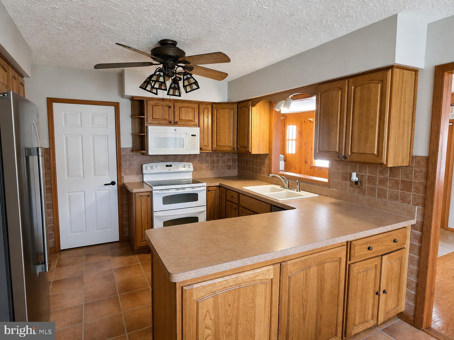 216 Georgetown Road Glassboro, NJ 08028 - Photo 7 of 17 a kitchen with stainless steel appliances granite countertop a sink stove and refrigerator