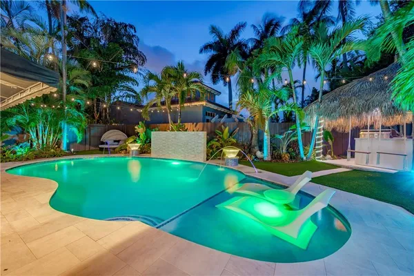 a view of a backyard with swimming pool