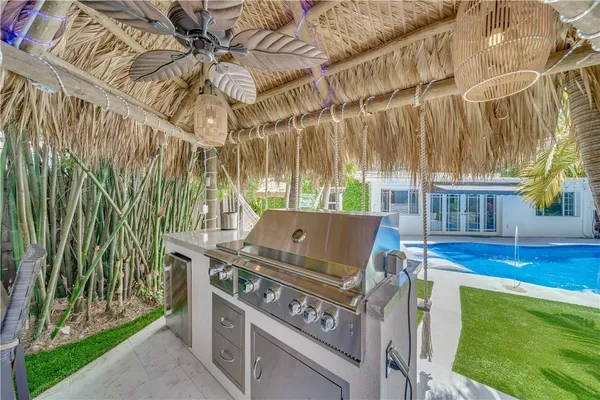 a view of a patio with a table chairs and a fire pit