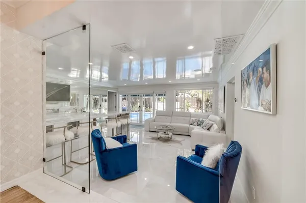a living room with furniture and kitchen view