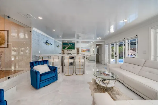 a living room with furniture and view of kitchen