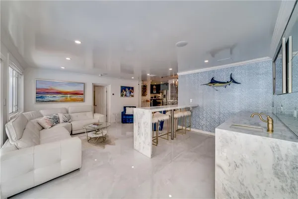 a kitchen with stainless steel appliances kitchen island granite countertop a table and chairs in it