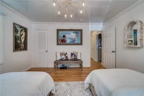 a bedroom with a bed and a chandelier