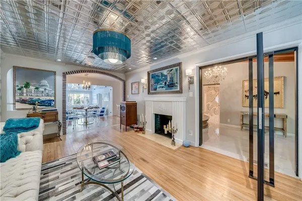 a living room with furniture a fireplace and a floor to ceiling window