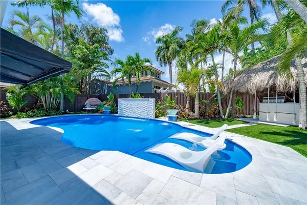 a view of a backyard with swimming pool
