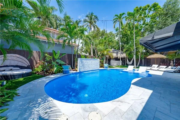 a view of a swimming pool with sitting area
