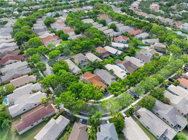 an aerial view of residential houses with outdoor space