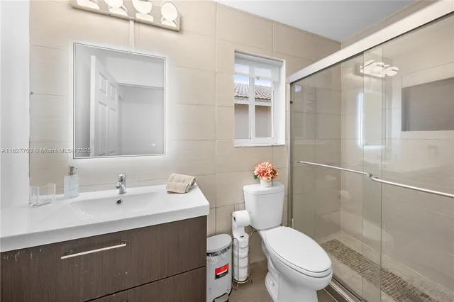 a bedroom with a large bed and a flat screen tv