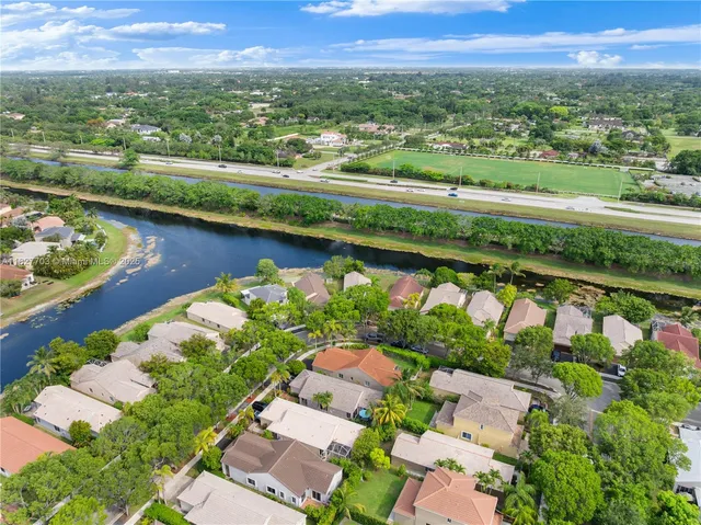 an aerial view of river residential house with swimming pool and outdoor space