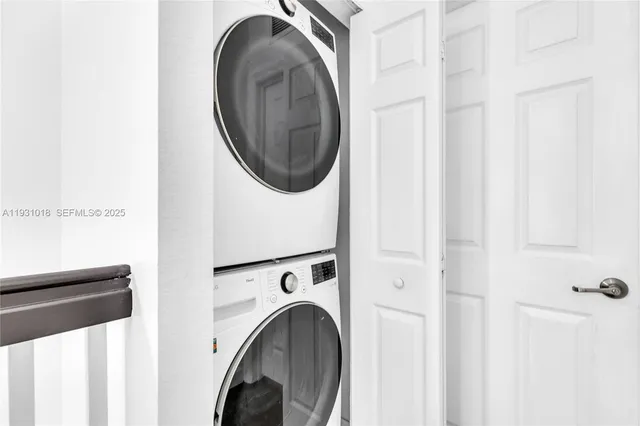 a view of a hallway with washer and dryer