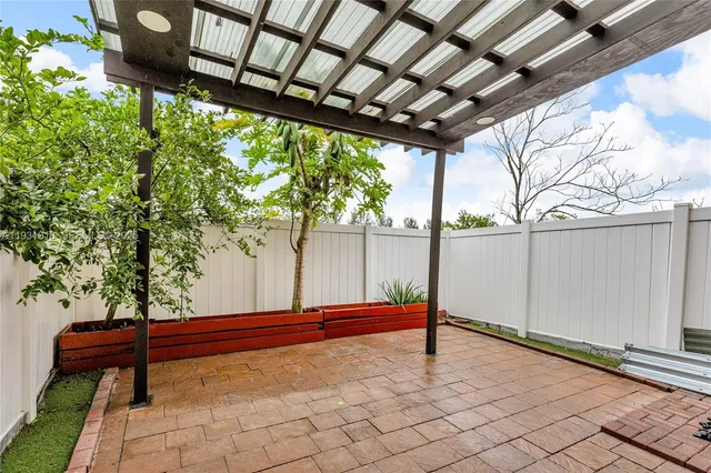 a backyard of a house with wooden floor and fence