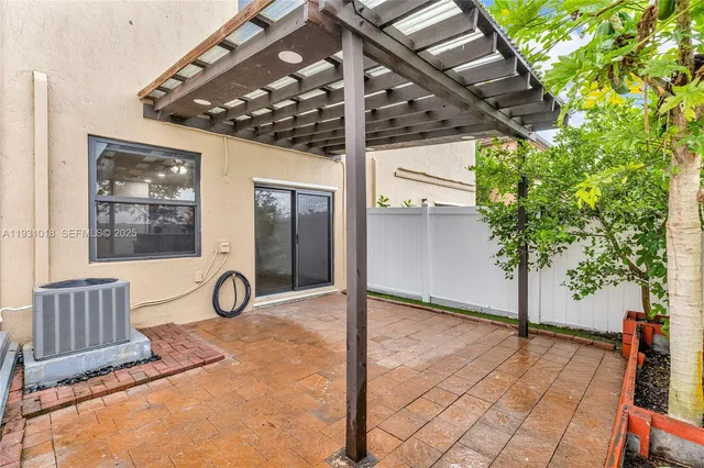 a view of a porch with furniture and a yard