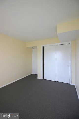 a view of an empty room and closet area