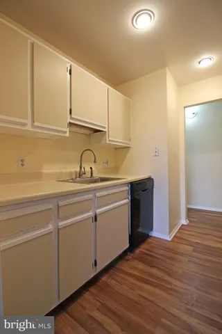 a kitchen with sink and cabinets