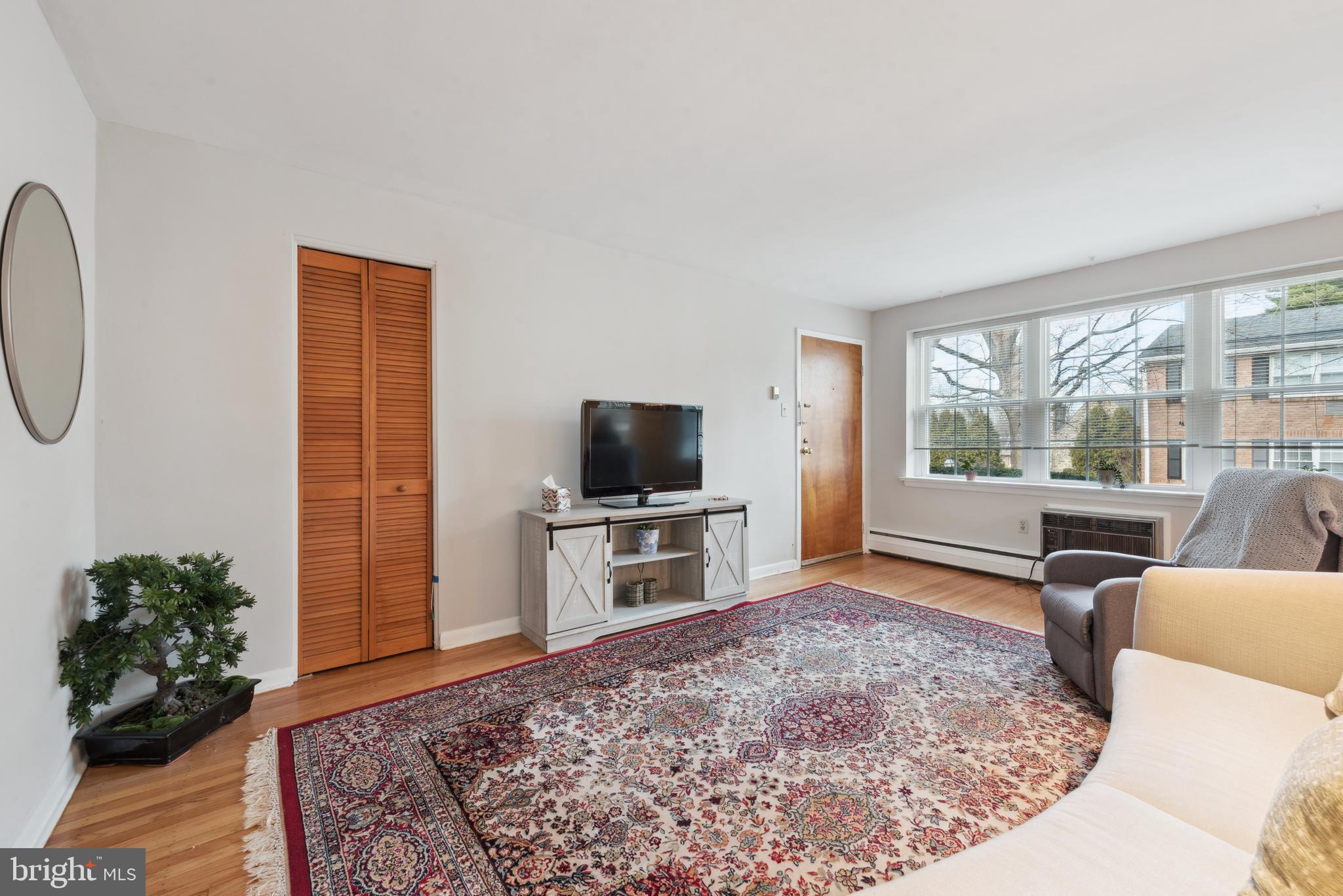 1334 Montgomery Avenue, Unit D3 Narberth, PA 19072 - Photo 4 of 15 a living room with furniture and a flat screen tv