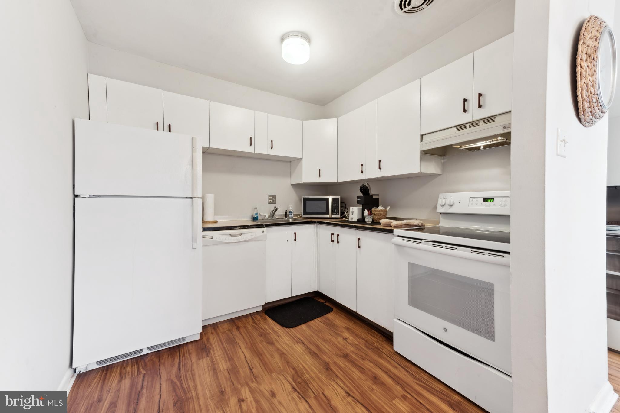 1334 Montgomery Avenue, Unit D3 Narberth, PA 19072 - Photo 6 of 15 a kitchen with granite countertop white cabinets and white appliances