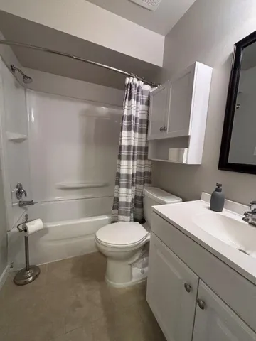 a bathroom with a sink a toilet and mirror