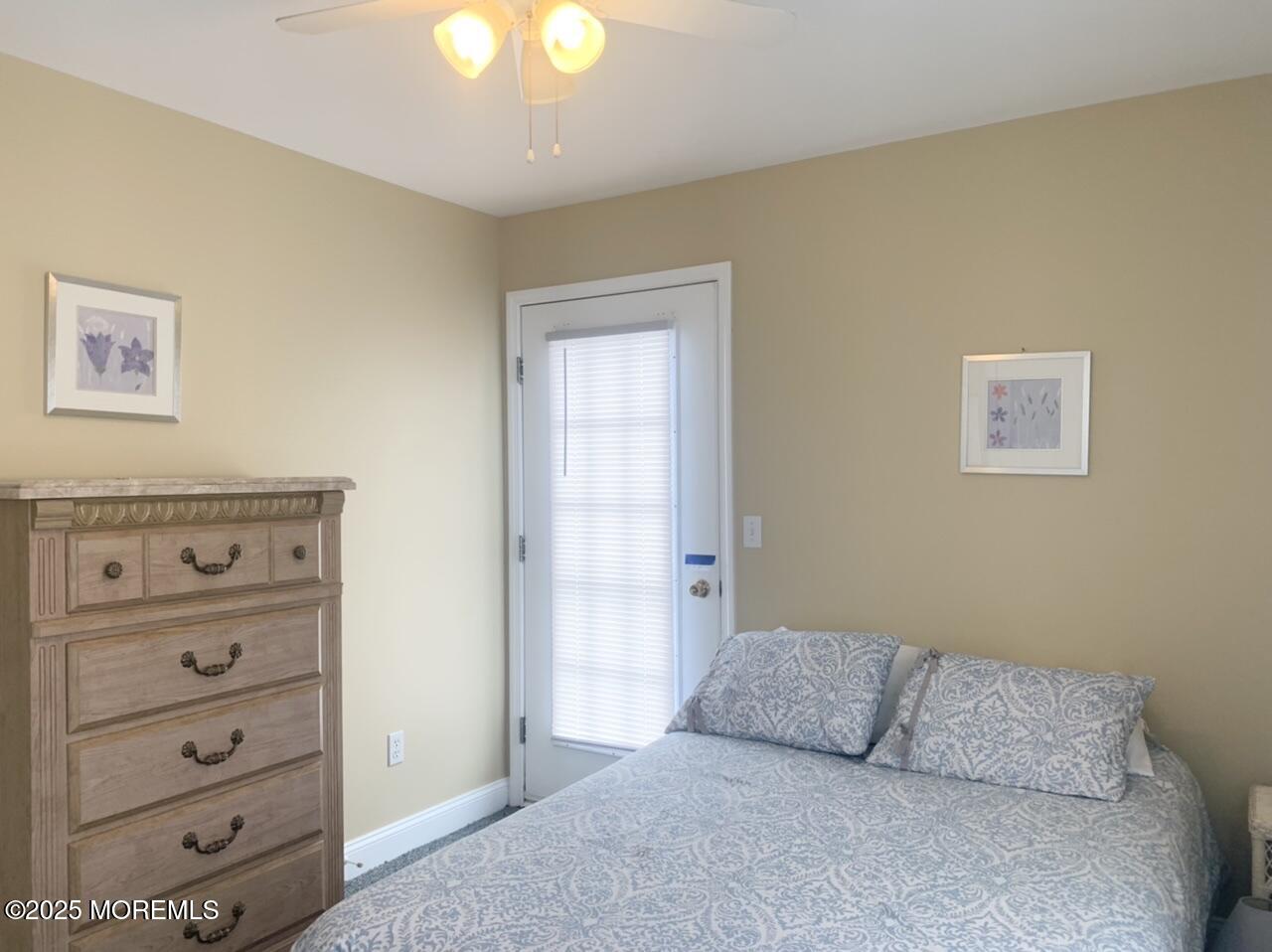 15 9th Avenue, Unit UPPR Seaside Park, NJ 08752 - Photo 12 of 24 a bedroom with a bed and a mirror