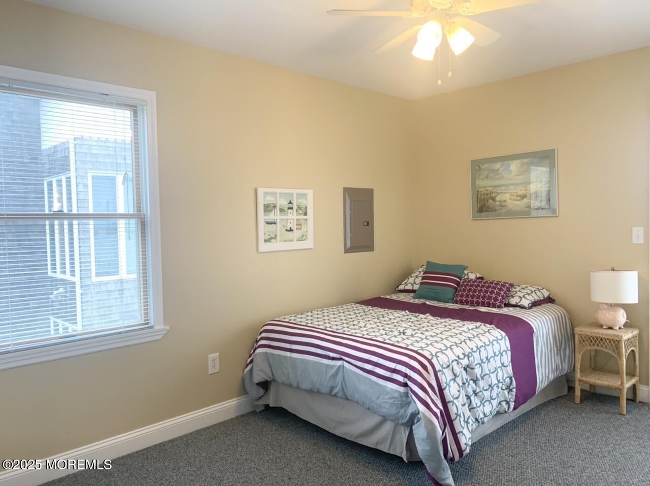15 9th Avenue, Unit UPPR Seaside Park, NJ 08752 - Photo 14 of 24 a bedroom with a bed and a window