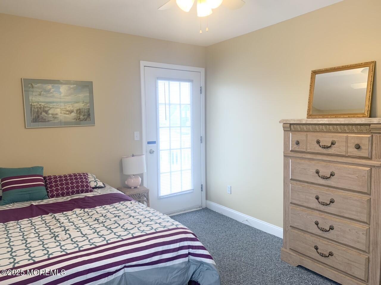 15 9th Avenue, Unit UPPR Seaside Park, NJ 08752 - Photo 15 of 24 a bedroom with a bed and with furniture