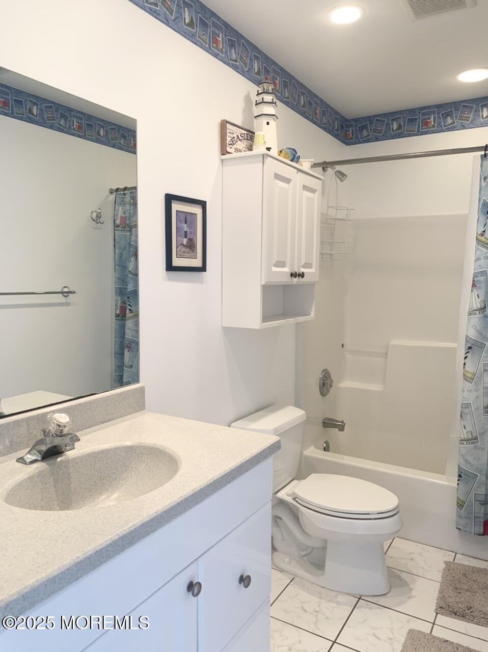 15 9th Avenue, Unit UPPR Seaside Park, NJ 08752 - Photo 17 of 24 a bathroom with a sink a toilet and shower