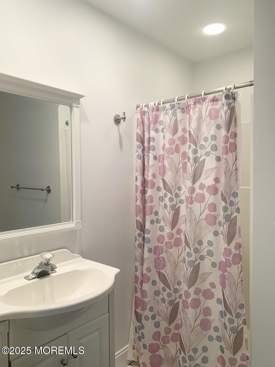 15 9th Avenue, Unit UPPR Seaside Park, NJ 08752 - Photo 18 of 24 a bathroom with a sink a toilet and a mirror