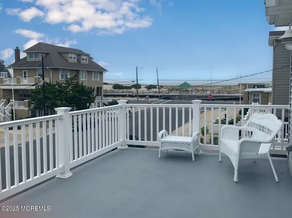 a view of a terrace with two chairs and a table