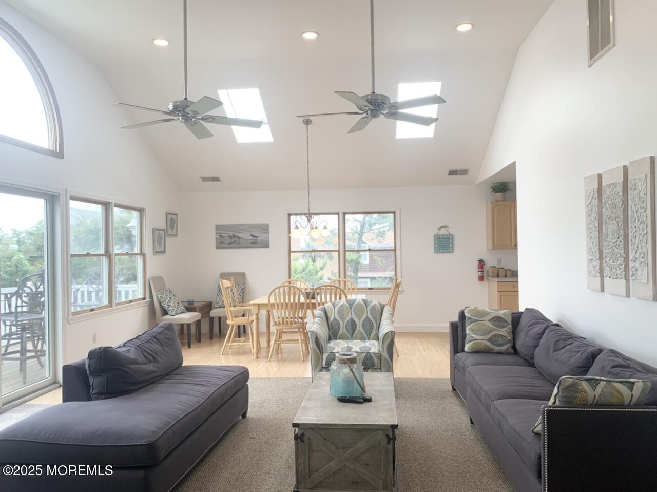 15 9th Avenue, Unit UPPR Seaside Park, NJ 08752 - Photo 2 of 24 a living room with furniture ceiling fan and a large window