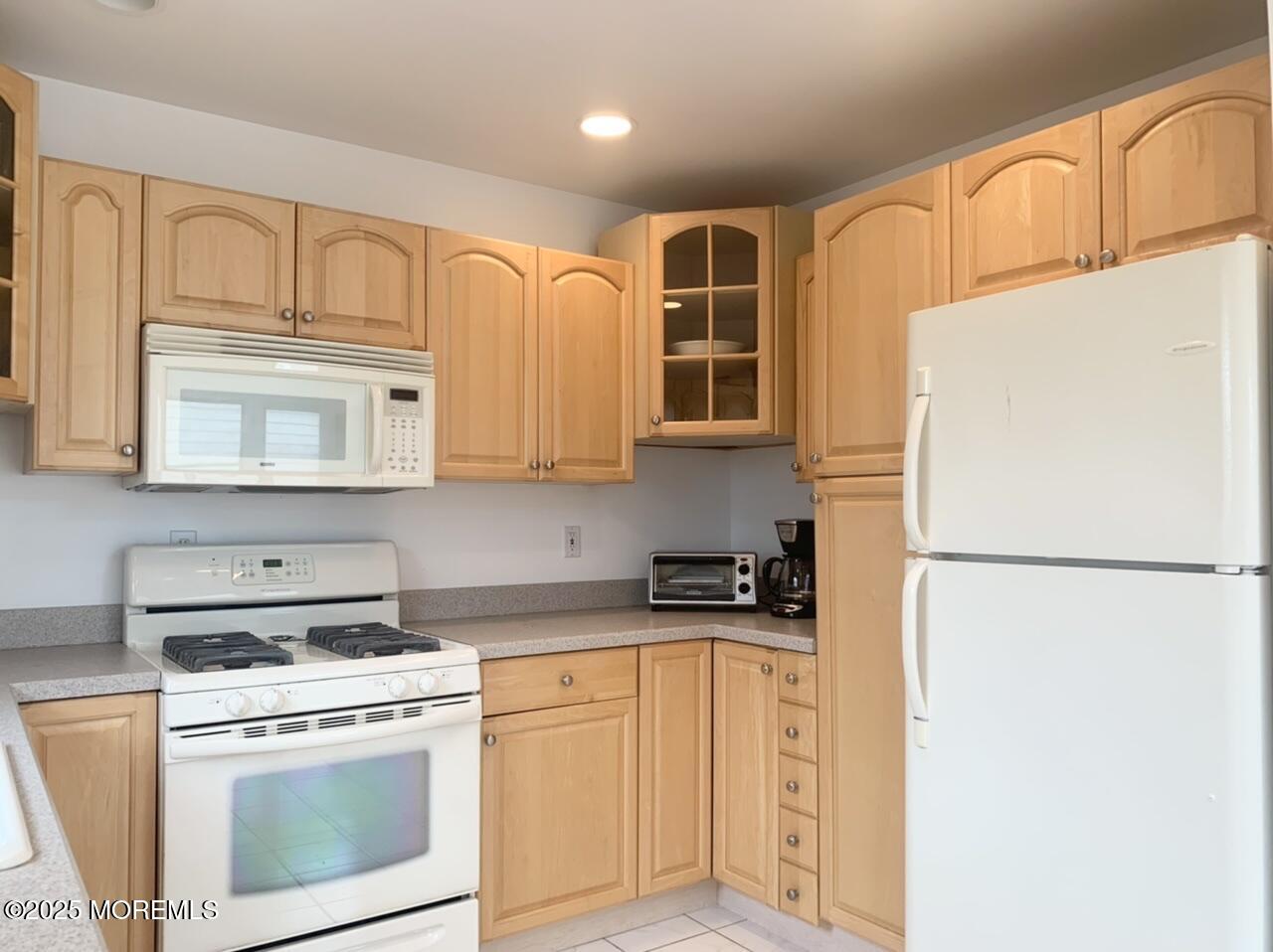 15 9th Avenue, Unit UPPR Seaside Park, NJ 08752 - Photo 9 of 24 a kitchen with stainless steel appliances granite countertop a refrigerator sink stove and white cabinets