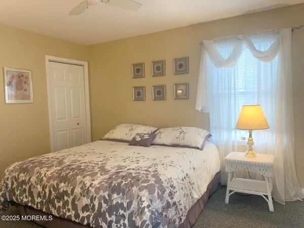 a bedroom with a bed and a lamp