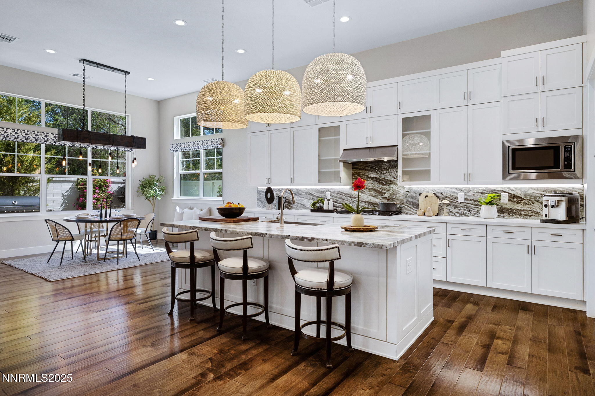 709 West Pleasant Oak Trail Reno, NV 89511 - Photo 11 of 44 a kitchen with stainless steel appliances granite countertop a stove top oven a sink a dining table and chairs with wooden floor